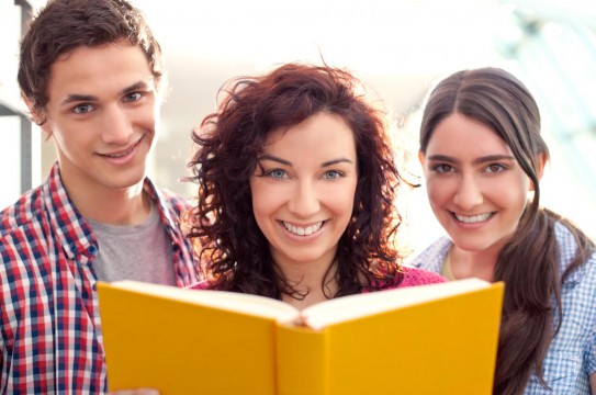 Students-Reading-At-The-Library-Books-Smiling-Friends